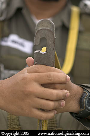 Border Patrol Police: Static line hook being held by a member of the Royal Thai Police. Hua Hin, Thailand.